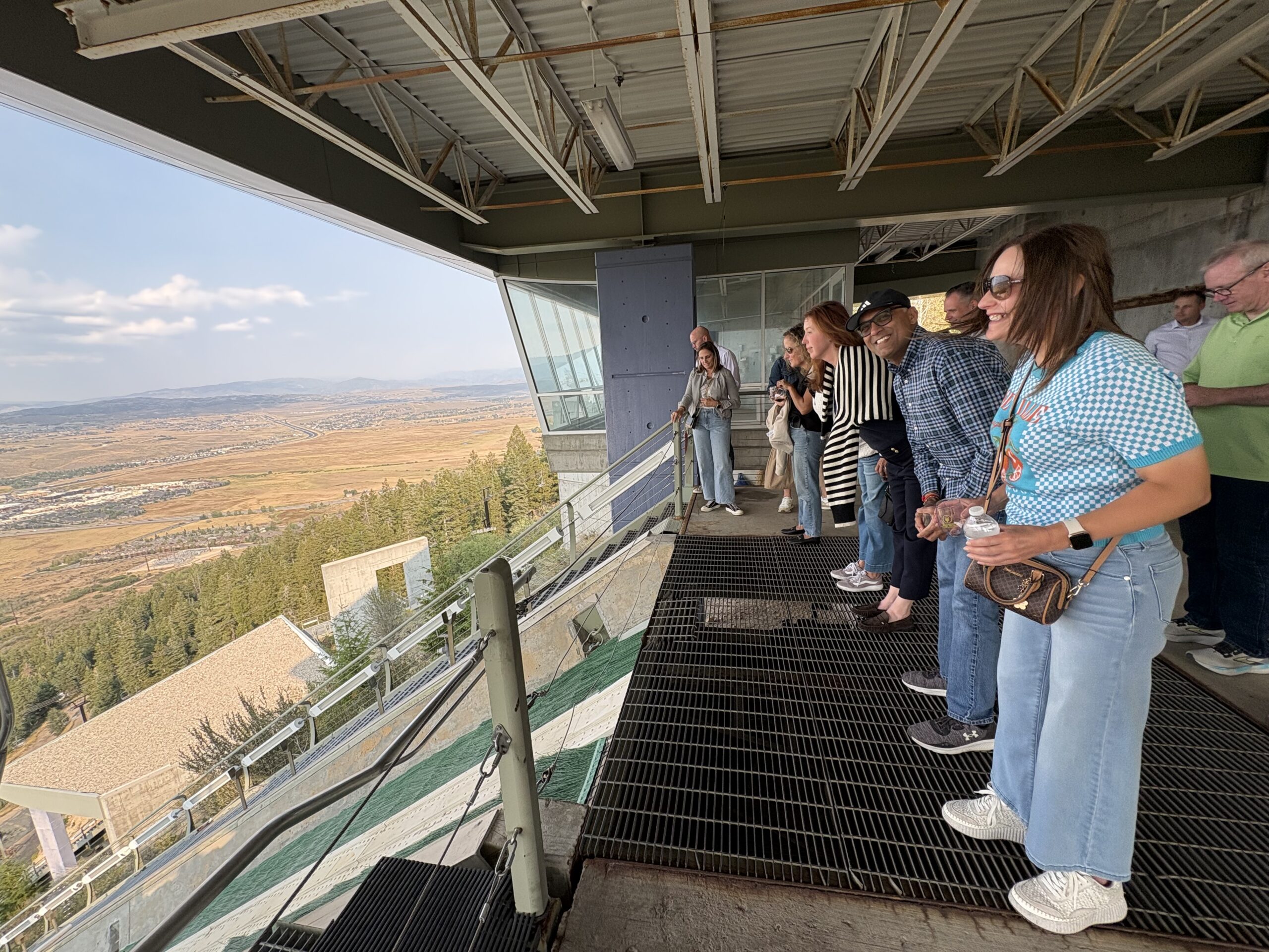 Guests pretend to ski jump at the top of the K120